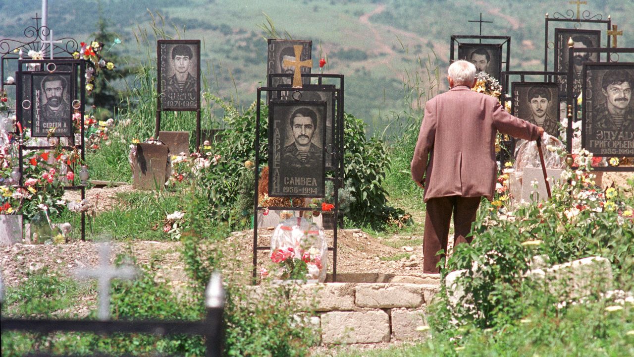 An Armenian man visits his son's grave at a memorial cemetery in Stepanakert, Azerbaijan, the capital of Nagorno Karabakh, in June 1994. 