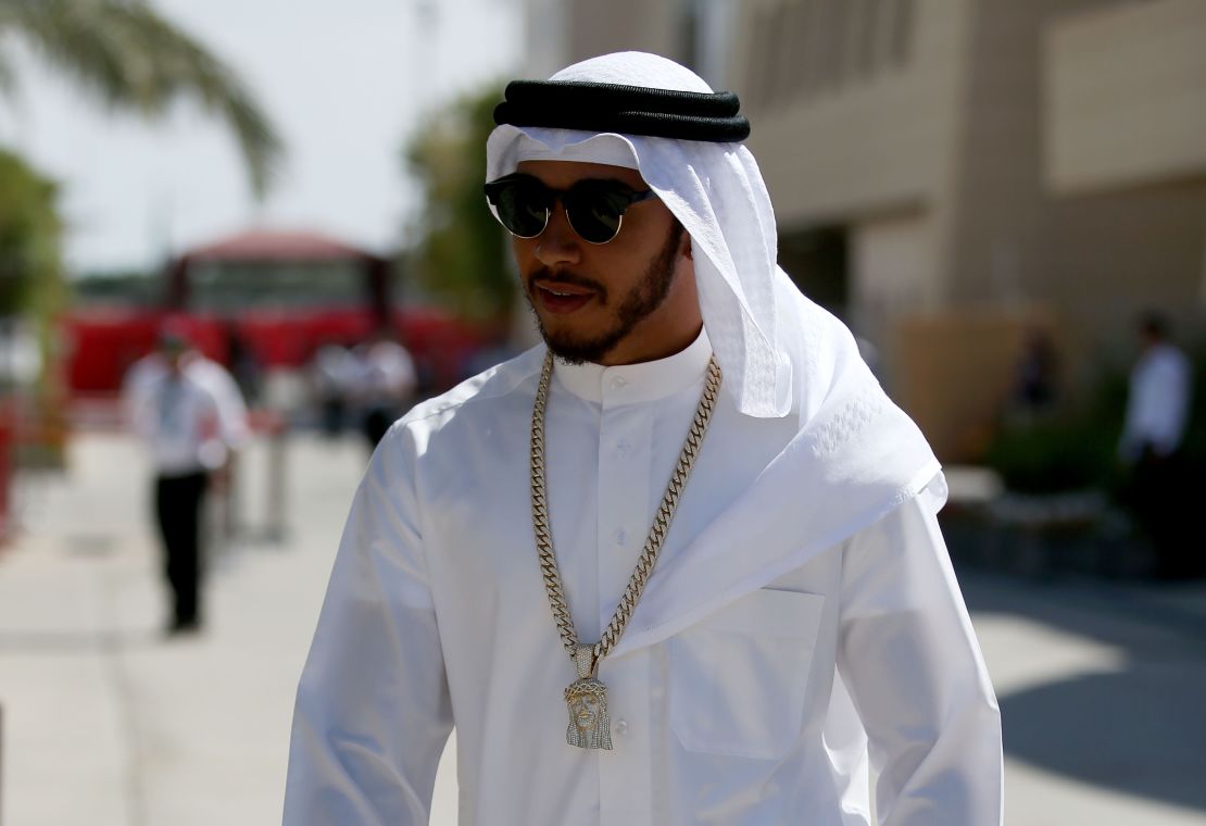 Lewis Hamilton walks through the paddock in Arabic dress ahead of the 2016 Bahrain F1 Grand Prix.