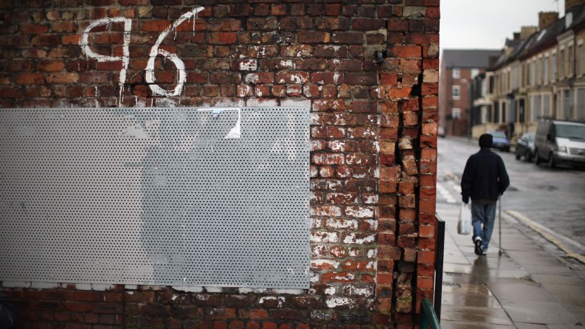 LIVERPOOL, UNITED KINGDOM - DECEMBER 19:  A man walks past Justice for the 96 graffiti outside Liverpool Football Club as the High Court quashes the 'Accidental Death' verdict on December 19, 2012 in Liverpool, England. An application presented by the Attorney General, Dominic Grieve to Lord Chief Justice Lord Judge has resulted in the quashing of the original accidental death verdict and an order for fresh inquests. The Hillsborough disaster occurred during the FA Cup semi-final tie between Liverpool and Nottingham Forest football clubs in April 1989 at the Hillsborough Stadium in Sheffield, which resulted in the deaths of 96 football fans.  (Photo by Christopher Furlong/Getty Images)