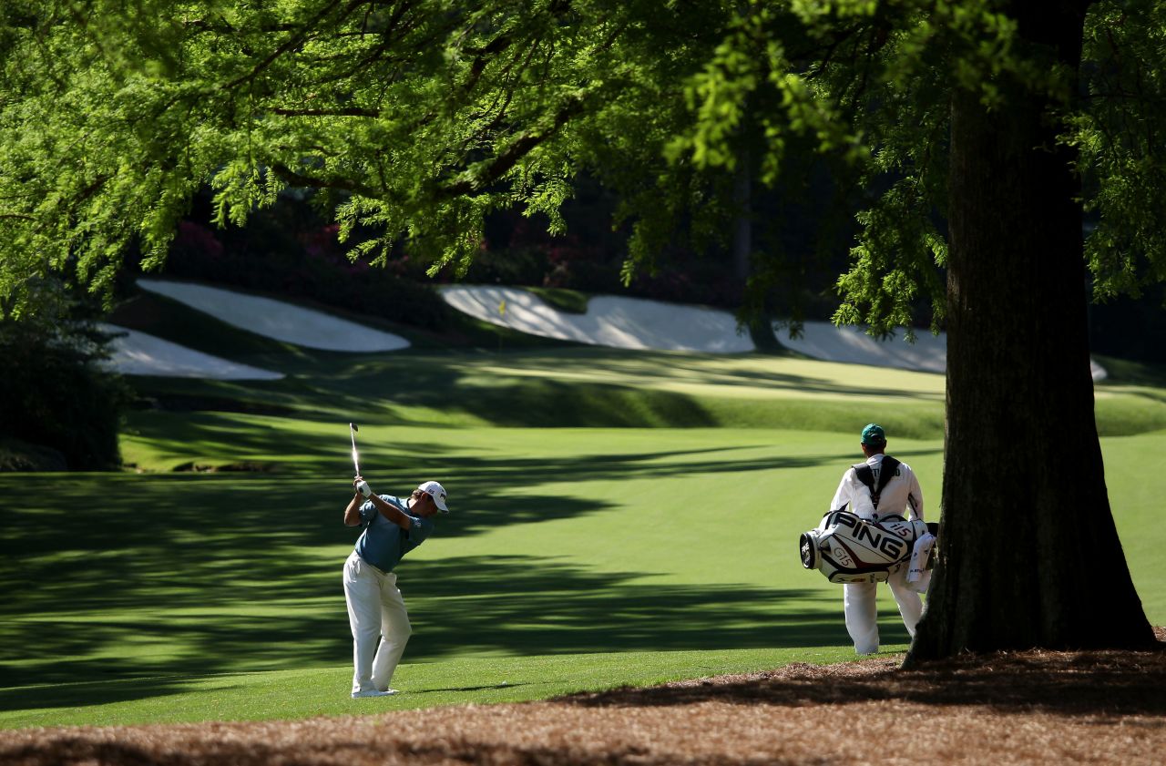 Foster looks on as Westwood plays his second shot at the par 5 13th hole at Augusta National. "It's a very demanding week, not only physically, because the elevation changes are so severe, but it's the most mentally demanding golf course we play all season. You can't switch off for one second or it will make you look stupid."