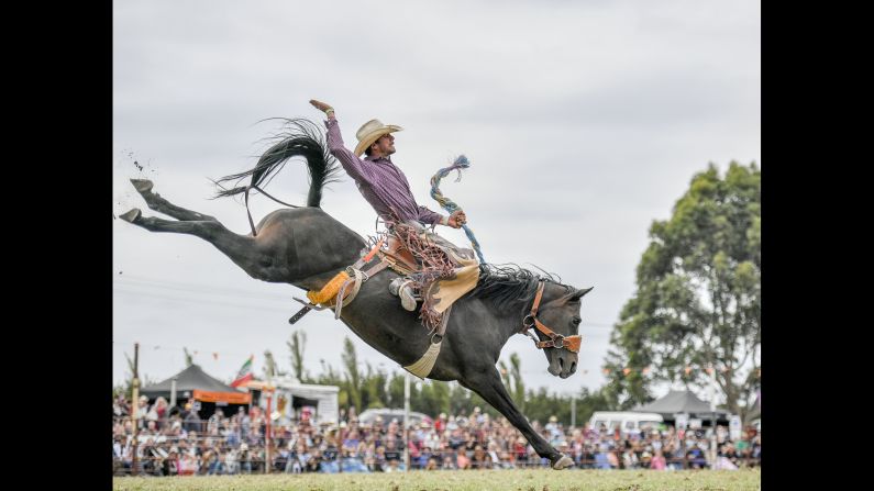 A competitor rides a bronco during the Lang Lang Rodeo, one of Australia's oldest rodeos, on Monday, March 28.