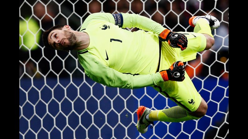 French goalkeeper Hugo Lloris dives for a shot but can't make the save during a friendly match against Russia on Tuesday, March 29. It was France's <a href="index.php?page=&url=http%3A%2F%2Fwww.cnn.com%2F2016%2F03%2F29%2Ffootball%2Fgallery%2Ffootball-brussels-paris-portugal%2Findex.html" target="_blank">first match at the Stade de France</a> since the Paris terror attacks in November.