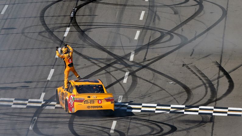 NASCAR driver Kyle Busch celebrates on top of his car after winning the Sprint Cup race in Martinsville, Virginia, on Sunday, April 3. It was the first victory of the season for Busch, who won the Sprint Cup title in 2015.