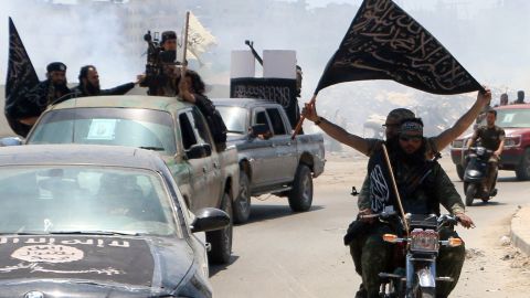 Fighters from al Qaeda's Syrian affiliate, al Nusra Front, drive in the northern Syrian city of Aleppo flying Islamist flags.