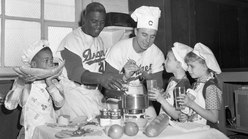 Robinson and Dodgers teammate "Pee Wee" Reese cook soup with their children in 1950. Reese was a big Robinson supporter, especially during that difficult first season. When some teammates wanted to boycott Robinson's addition to the team, Reese refused to sign the petition. And <a href="index.php?page=&url=https%3A%2F%2Fwww.espn.com%2Fblog%2Fplaybook%2Ffandom%2Fpost%2F_%2Fid%2F20917%2Fdid-reese-really-embrace-robinson-in-47" target="_blank" target="_blank">as the story goes,</a> Reese once put his arm around Robinson's shoulders in the middle of a road game, embracing Robinson as he was being heckled.