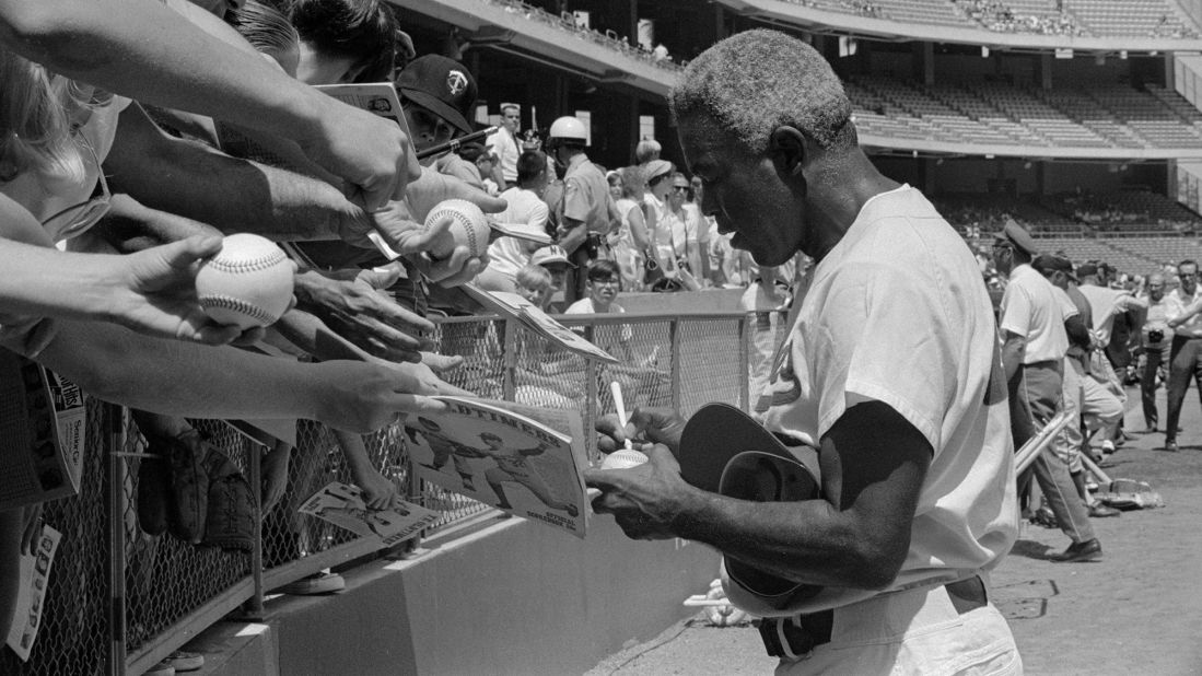 Robinson signs autographs before the start of an Old Timers Game in Anaheim, California, in 1969. Three years later, he died of a heart attack at the age of 53.