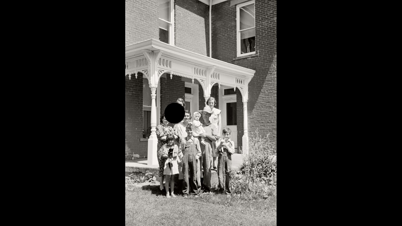 A family poses for a photo at an Ohio farm in 1938. "When I first began working with the killed negatives, I was disturbed by the images of people whose faces had been excised by the hole punch," McDowell says in the book. "In fact, early on that motivated me to digitally repair the hole and show the restored version along with the hole-punched one. But I kept coming back to the feeling that the black-holed images were far more fascinating ... and that the violation (or violence) embedded in them had the potential to signify so much."