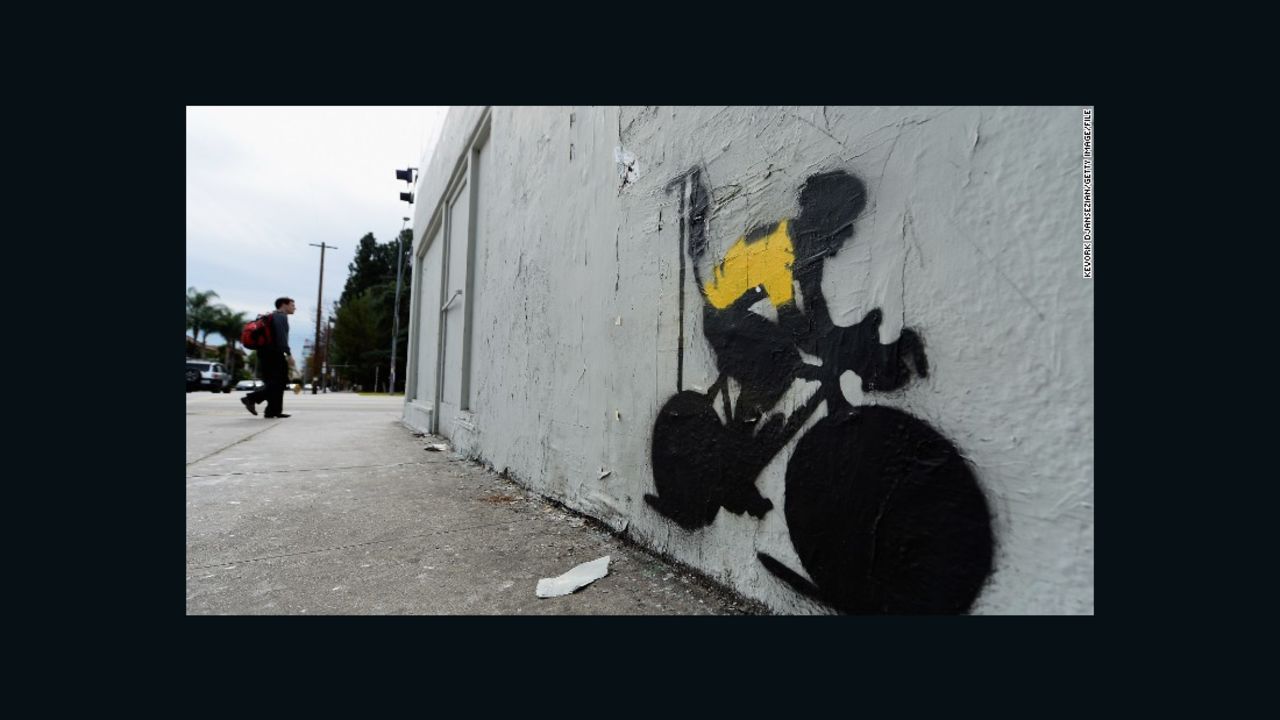 A stencil graffiti depicting Armstrong in a Tour leader's yellow jersey, attached to an IV drip.