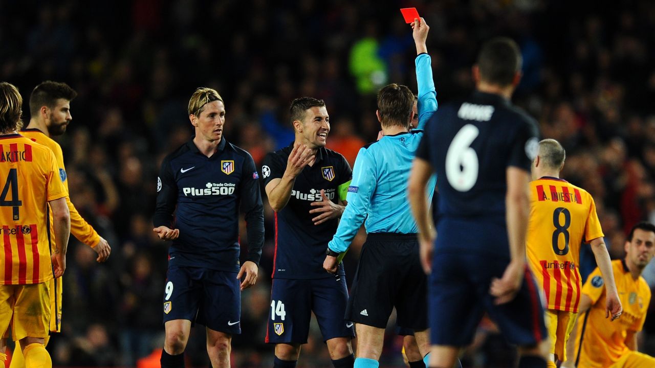 Torres is shown the red card by referee Felix Brych after a second rash challenge.