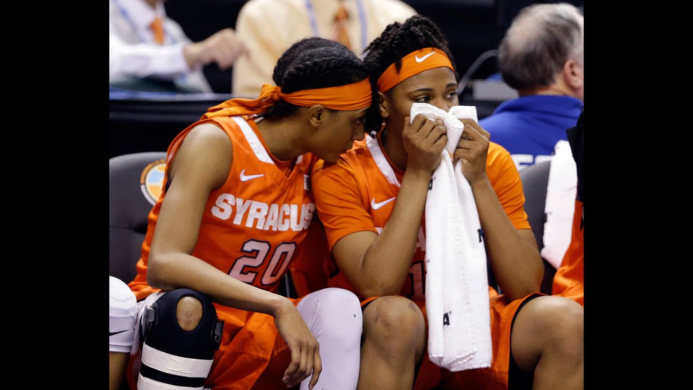 Syracuse's Brittney Sykes, left, and teammate Cornelia Fondren sit on the bench during the second half of the game.
