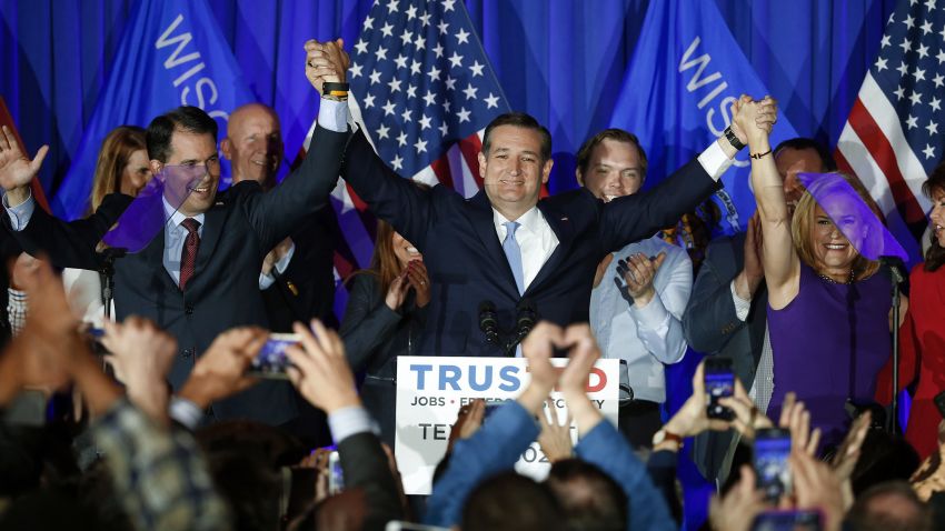 Republican presidential candidate Senator Ted Cruz, raises hands with Wisconsin Governor Scott Walker, left, and his wife Heidi, right, during a primary night campaign event, Tuesday, April 5, 2016, in Milwaukee.