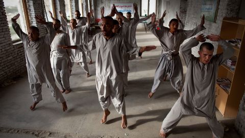 Drug addicts exercise at a rehab center in Kabul. 