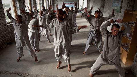 Drug addicts exercise at a rehab center in Kabul.