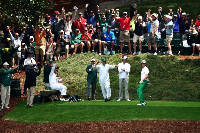 Webb Simpson of the United States celebrates with his caddie and the crowd after making a hole-in-one at the ninth. However, playing partner Bubba Watson looked far from impressed, perhaps the pair a hefty wager riding on the event?