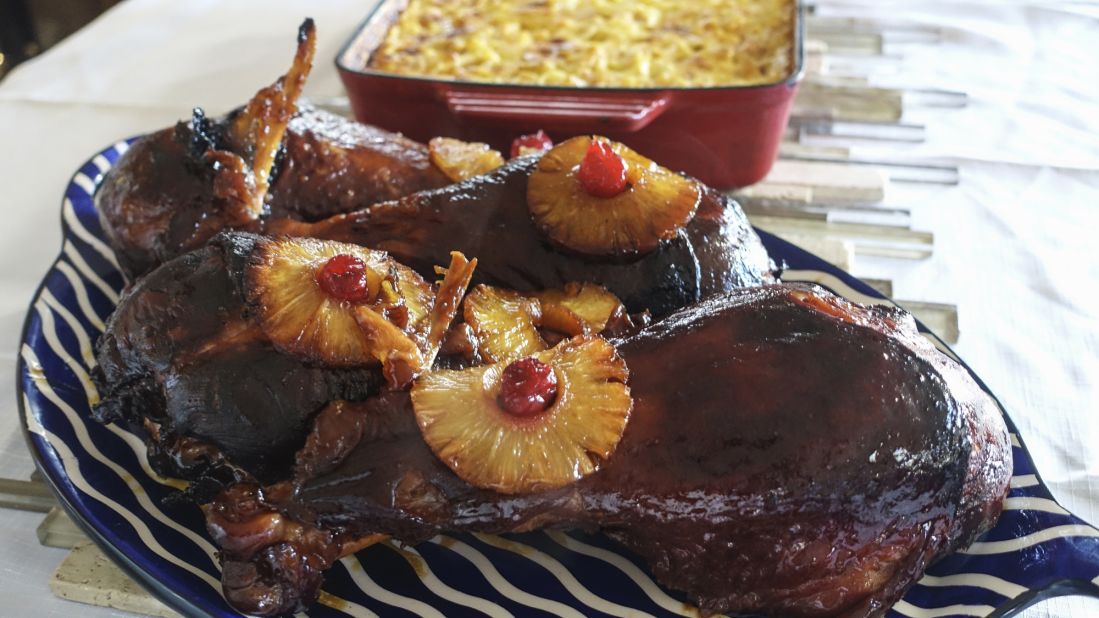 Lupe Fiasco's mom made glazed turkey legs for a family dinner that Bourdain joined.