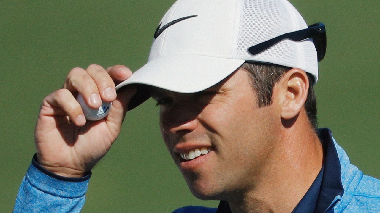 Paul Casey tips his cap after putting on the second hole Thursday.