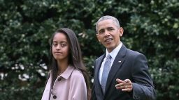 U.S. President Barack Obama walks with his daughter Malia toward Marine One while departing the White House April 7, 2016 in Washington, DC.