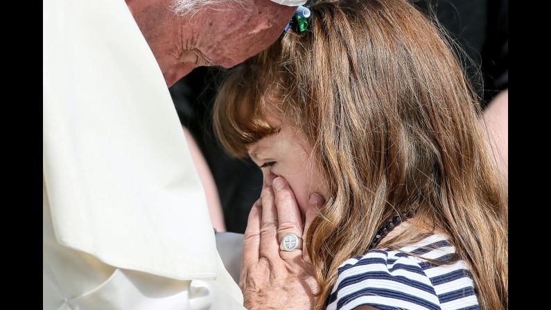 Pope Francis meets with Lizzy Myers at the Vatican on Wednesday, April 6. The girl <a href="http://www.cnn.com/2015/08/12/health/visual-bucket-list/" target="_blank">is gradually losing her sight and hearing</a> because of a rare genetic disease.