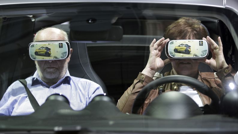 A woman in Berlin holds virtual-reality 3-D glasses before a shareholders meeting for automaker Daimler AG on Wednesday, April 6.