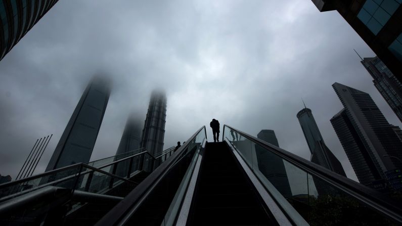 A man rides an escalator in the Lujiazui financial district of Shanghai, China, on Wednesday, April 6.