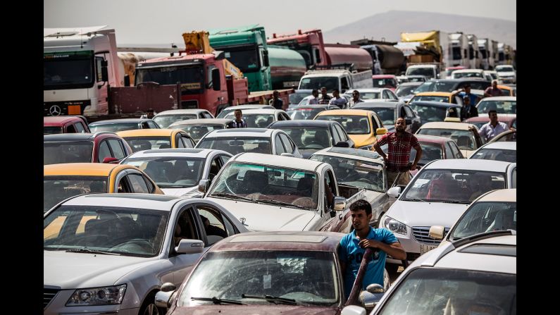 Traffic from Mosul lines up at a checkpoint in Kalak, Iraq, on June 14, 2014. Thousands of people <a href="index.php?page=&url=http%3A%2F%2Fwww.cnn.com%2F2014%2F07%2F19%2Fworld%2Fmeast%2Fchristians-flee-mosul-iraq%2F" target="_blank">fled Mosul</a> after it was overrun by ISIS.