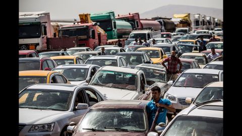 Traffic from Mosul lines up at a checkpoint in Kalak, Iraq, on June 14, 2014. Thousands of people <a href="http://www.cnn.com/2014/07/19/world/meast/christians-flee-mosul-iraq/" target="_blank">fled Mosul</a> after it was overrun by ISIS.