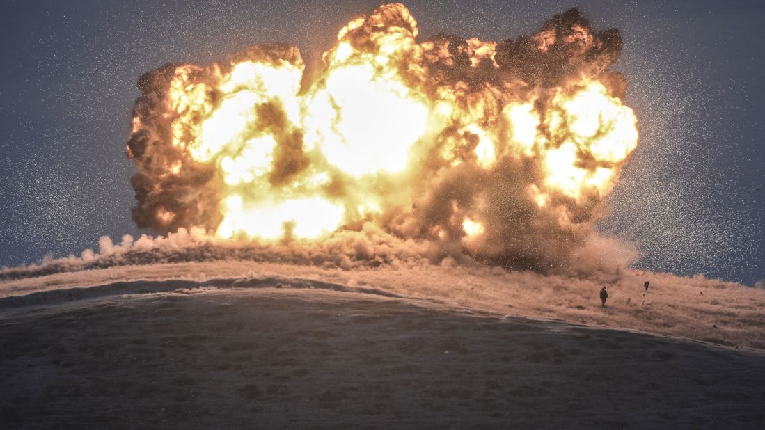 ISIS militants stand near the site of an airstrike near the Turkey-Syria border on October 23, 2014. The United States and several Arab nations <a href="http://www.cnn.com/2014/09/22/world/meast/u-s-airstrikes-isis-syria/" target="_blank">began bombing ISIS targets in Syria</a> to take out the group's ability to command, train and resupply its fighters.