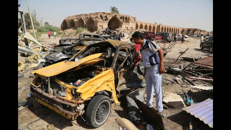 A man inspects the aftermath of a car bombing in Khan Bani Saad, Iraq, on July 18, 2015. <a href="index.php?page=&url=http%3A%2F%2Fwww.cnn.com%2F2015%2F07%2F18%2Fmiddleeast%2Firaq-violence%2F" target="_blank">A suicide bomber with an ice truck,</a> promising cheap relief from the scorching summer heat, lured more than 100 people to their deaths. ISIS claimed responsibility on Twitter.