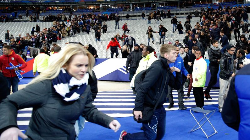 Spectators at the Stade de France in Paris run onto the soccer field after explosions were heard outside the stadium on November 13, 2015. Three teams of gun-wielding ISIS militants <a href="index.php?page=&url=http%3A%2F%2Fwww.cnn.com%2F2015%2F11%2F17%2Feurope%2Fparis-attacks-at-a-glance%2F" target="_blank">hit six locations around the city,</a> killing at least 129 people and wounding hundreds.