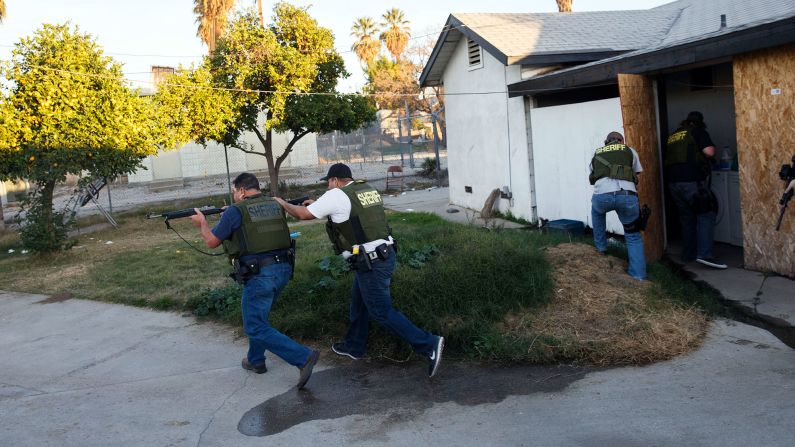 Law enforcement officers search a residential area in San Bernardino, California, after a <a href="index.php?page=&url=http%3A%2F%2Fwww.cnn.com%2F2015%2F12%2F02%2Fus%2Fgallery%2Fsan-bernardino-shooting%2Findex.html" target="_blank">mass shooting</a> killed at least 14 people and injured 21 on December 2, 2015. <a href="index.php?page=&url=http%3A%2F%2Fwww.cnn.com%2F2015%2F12%2F03%2Fus%2Fsan-bernardino-shooting%2Findex.html" target="_blank">The shooters</a> -- Syed Rizwan Farook and his wife, Tashfeen Malik -- were fatally shot in a gunbattle with police hours after the initial incident. The couple supported ISIS and had been planning the attack for some time, investigators said.