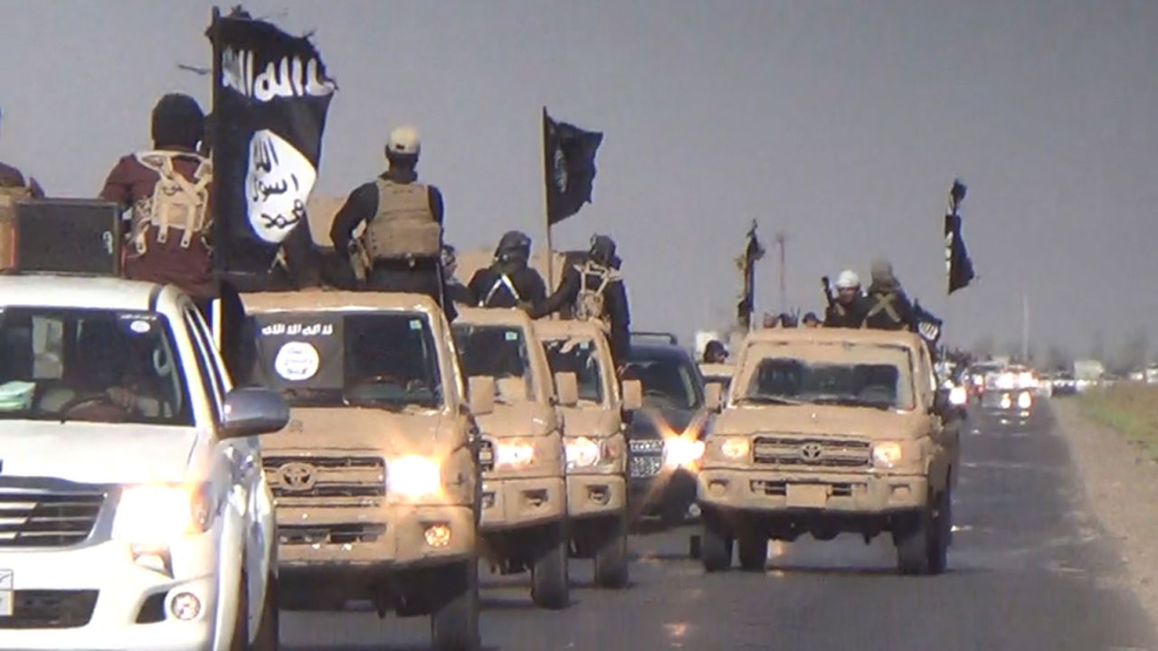 ISIS fighters parade down an Iraqi street in this image released by the group in July 2014.
