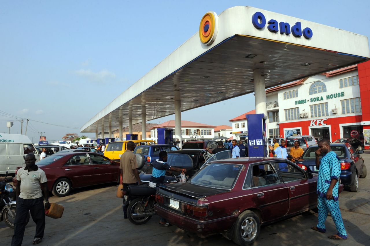 People wait in line to buy fuel at a gas station in Lagos on March 9, 2016, due to an ongoing fuel scarcity crisis in Nigeria.