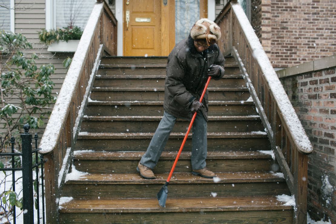 Hopkins clears the steps to his Victorian townhouse on a wintry Chicago day. He moved  to the Windy City to be closer to family.