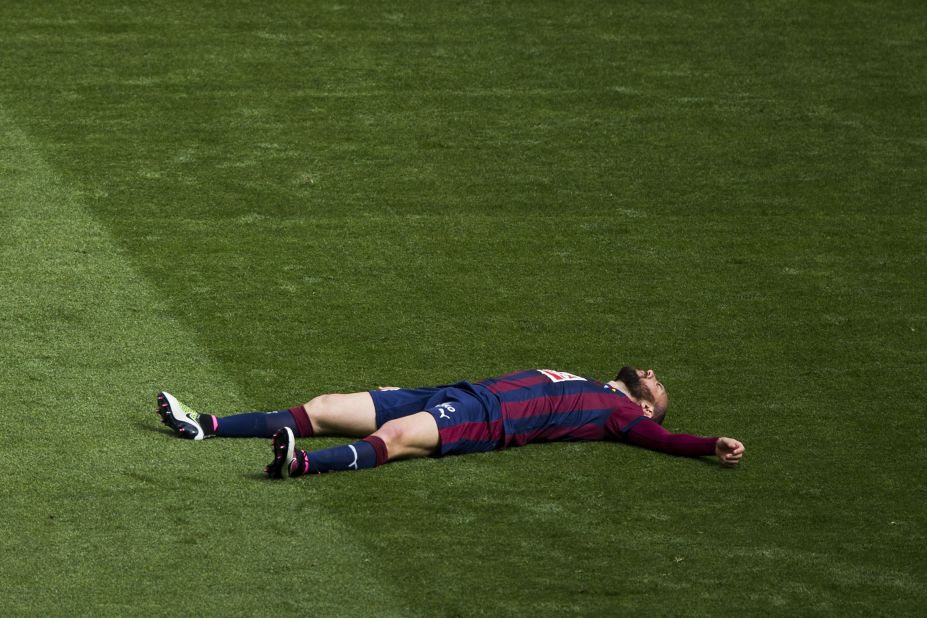 Ivan Ramis of Eibar lies flat out on the grass as his side is steamrollered by Real Madrid at the Santiago Bernabeu.