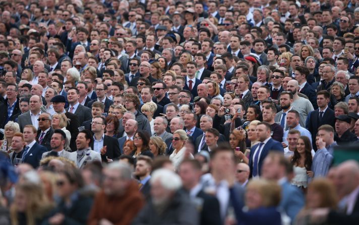 Fans look on engrossed by the action at the Aintree race course.