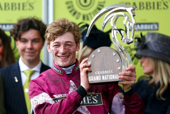 To the winner, the spoils. David Mullins poses for the cameras in the winners' enclosure.