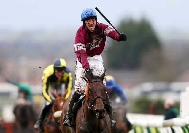 David Mullins, riding Rule The World, celebrates winning the 2016 Grand National steeplechase at the Aintree Racecourse in Liverpool, England.  