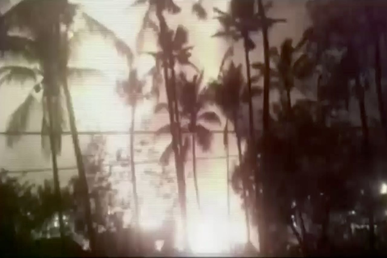 In this image made from video, a flash from an explosion is seen from the ground during a fireworks show at the temple.
