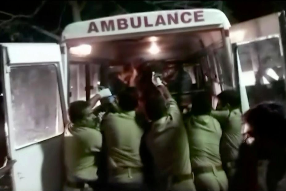 Officials put an injured person into an ambulance.