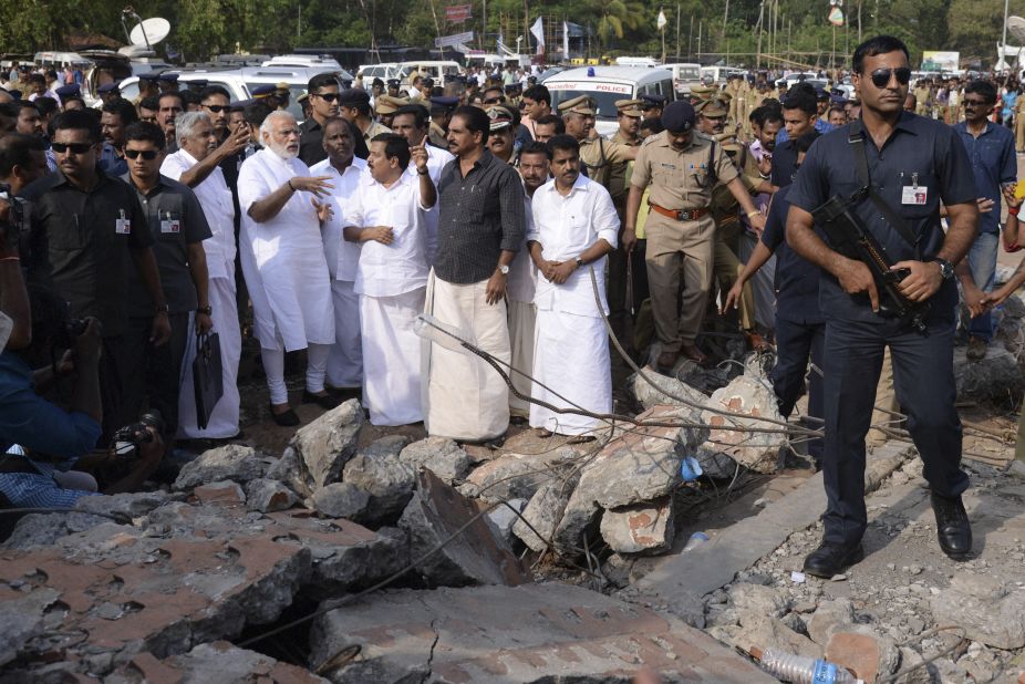 Indian Prime Minister Narendra Modi, second left, wearing white, visits the site.