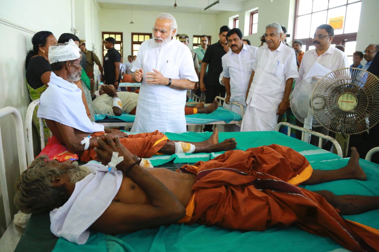 Modi, center, visits the injured victims at the Kollam district hospital.