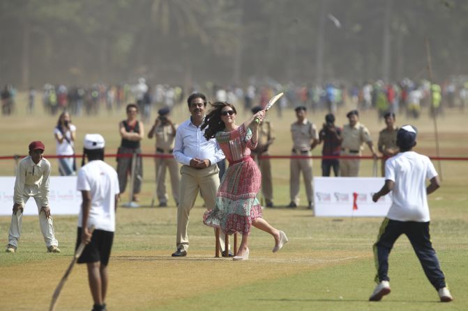 The duchess plays cricket with cricket legend Sachin Tendulkar at the Oval Maidan sporting ground in Mumbai on April 10.