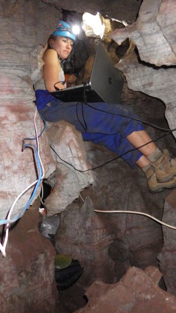 "It's damp, it's dark. If you slip in certain situations you can fall and injure yourself," explained Berger of Rising Star cave. Here, Lindsay Eaves manages to work on a laptop inside the cramped cave.