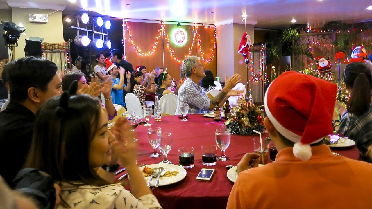 With a population that's more than 80% Catholic, Christmas is a very big deal in the Philippines. To get into the spirit, Bourdain attended a holiday office party in Manila.