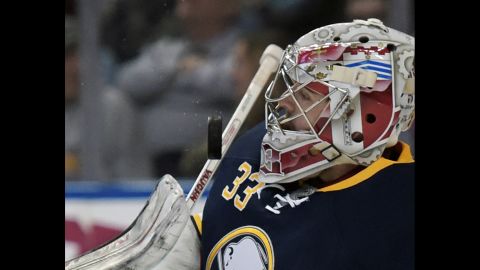 Buffalo goaltender Jason Kasdorf, making his NHL debut, takes a puck off the mask on Friday, April 8.