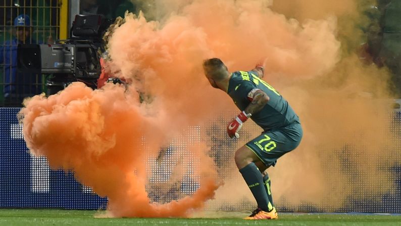A flare is thrown onto the field near Palermo goalkeeper Stefano Sorrentino during an Italian league match in Palermo on Sunday, April 10. The match was stopped twice because of crowd trouble, <a href="index.php?page=&url=http%3A%2F%2Fwww.bbc.com%2Fsport%2Ffootball%2F36011691" target="_blank" target="_blank">according to the BBC.</a>