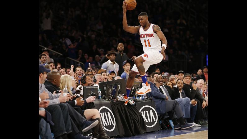 Cleanthony Early steps on a broadcast table as he tries to save a ball from going out of bounds Sunday, April 10, in New York.