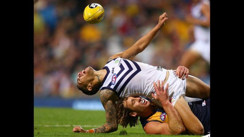 Matt Priddis of the West Coast Eagles tackles Michael Walters of the Fremantle Dockers during an Australian Football League match in Perth on Saturday, April 9.