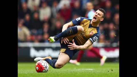 Arsenal's Laurent Koscielny reacts to a tackle by West Ham's Andy Carroll during a Premier League match in London on Saturday, April 9.