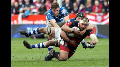 Gloucester Rugby's John Alofa is tackled by Nic Cudd of the Newport Gwent Dragons during a Challenge Cup match in Gloucester, England, on Saturday, April 9. The Dragons, who play in Newport, Wales, won 23-21 to advance to the semifinals of the European tournament.
